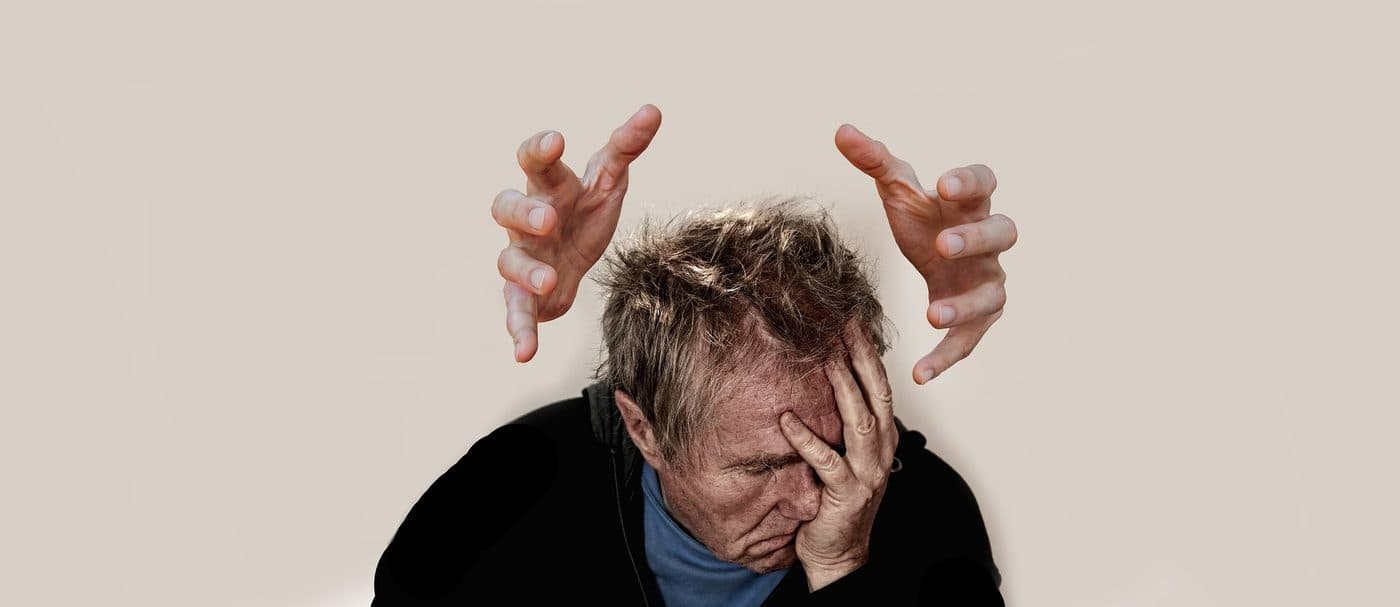 A person holding their head, with hands drawn above them to suggest pressure